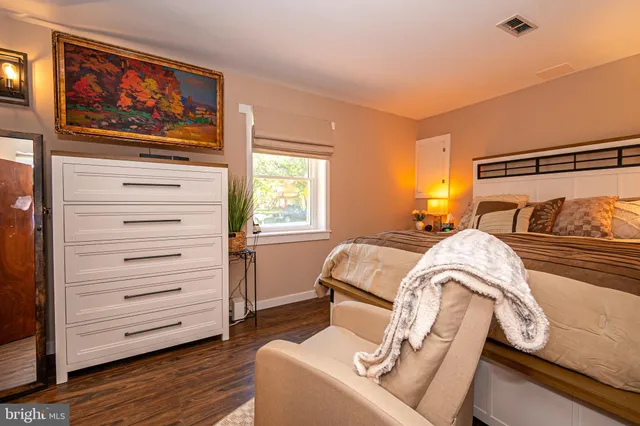 a bathroom with a shower curtain and a black umbrella