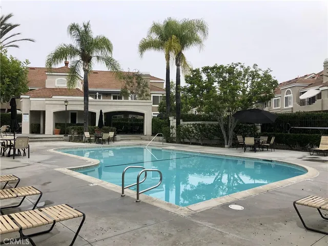 a swimming pool with outdoor seating and yard