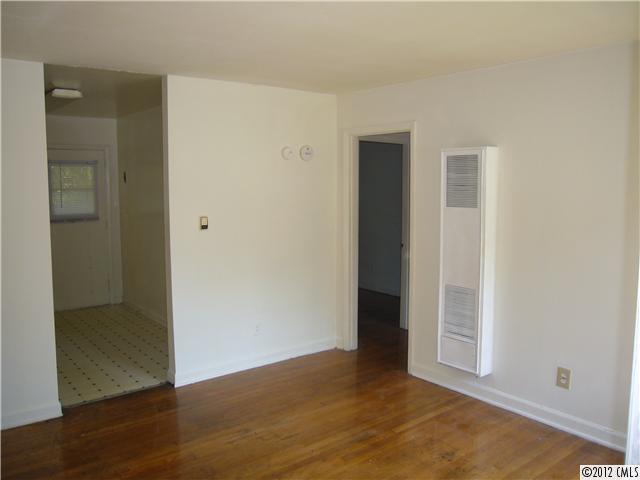 3834 Tuckaseegee Road, Unit 3 Charlotte, NC 28208 - Photo 2 of 3 an empty room with wooden floor and closet