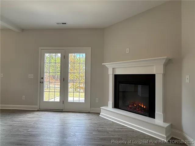 a large kitchen with stainless steel appliances granite countertop a stove a sink and a large window