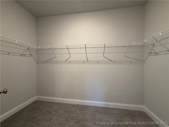 a spacious bathroom with a double vanity sink a toilet and a mirror