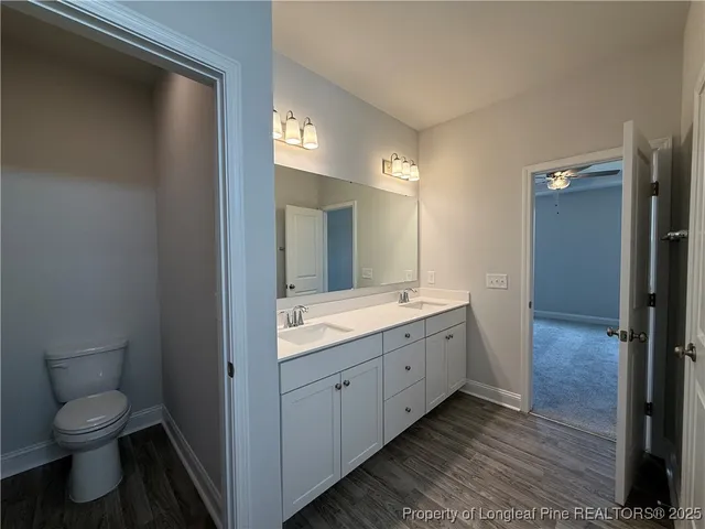 a bathroom with a double vanity sink and a mirror