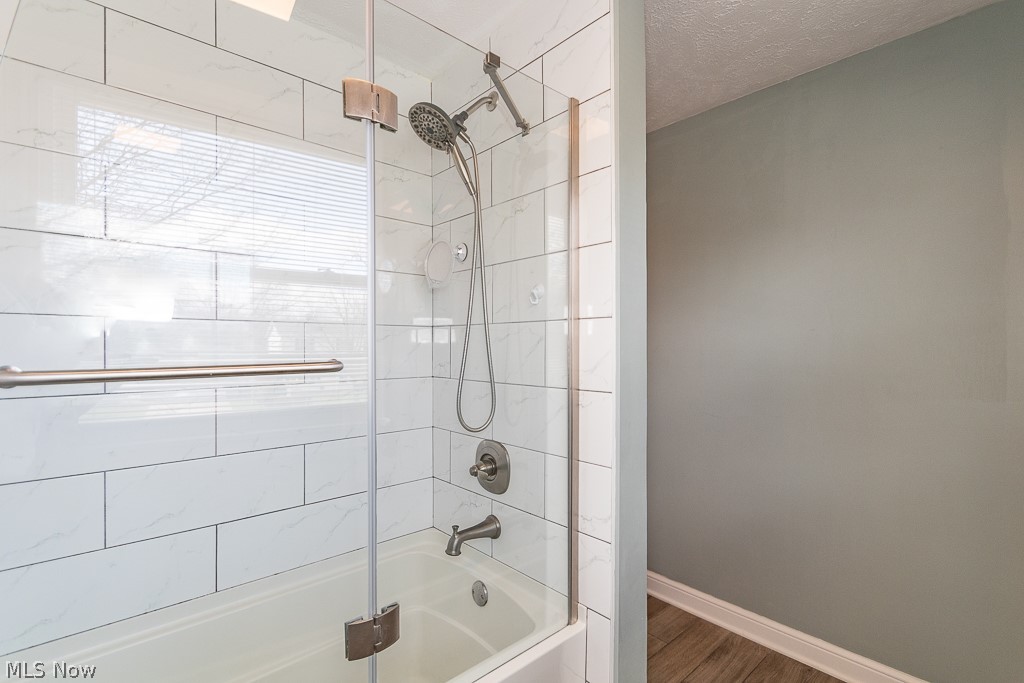 3080 Gale Road Willoughby, OH 44094 - Photo 37 of 45 Bathroom featuring tiled shower / bath, a textured ceiling, and hardwood / wood-style flooring