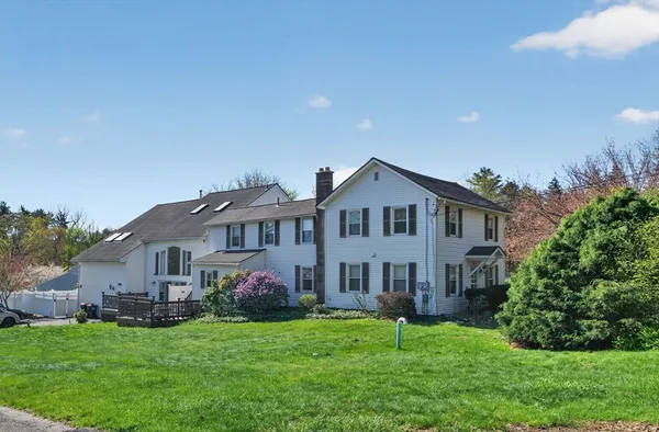 a front view of a house with a garden and plants