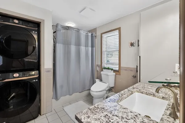 a bathroom with a sink a toilet and a tub