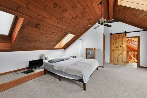 a bedroom with a bed and window