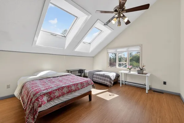 a bedroom with a bed and a window