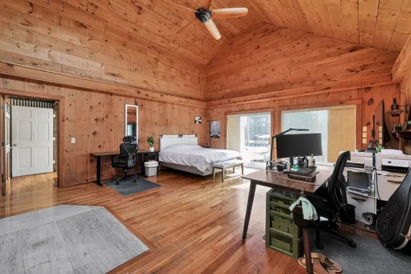 a bedroom with furniture and a wooden floor