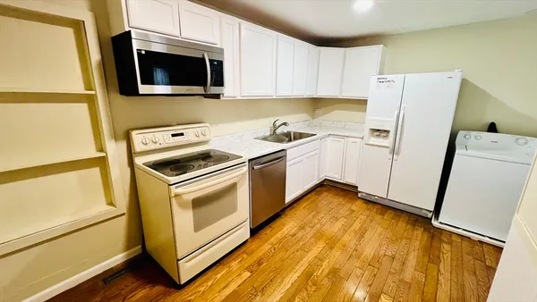 a kitchen with a sink and cabinets