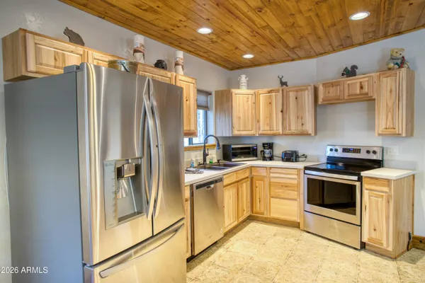 a kitchen with stainless steel appliances a refrigerator sink and cabinets