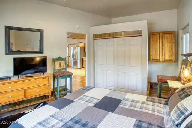 a bedroom with a bed and flat screen tv