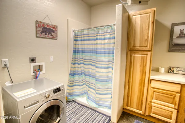 a bathroom with a sink a washer and dryer