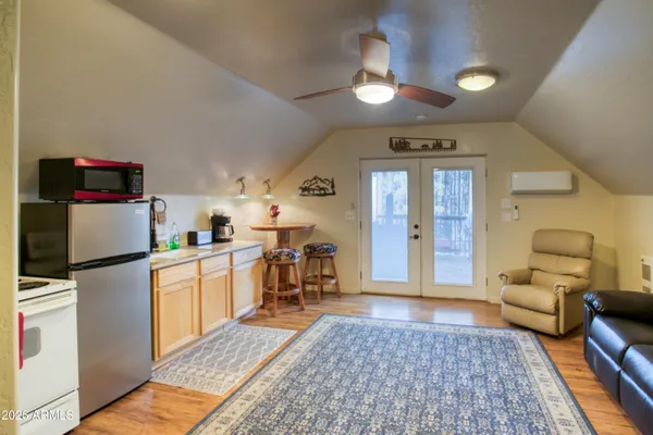 a kitchen with furniture a refrigerator and a coffee table