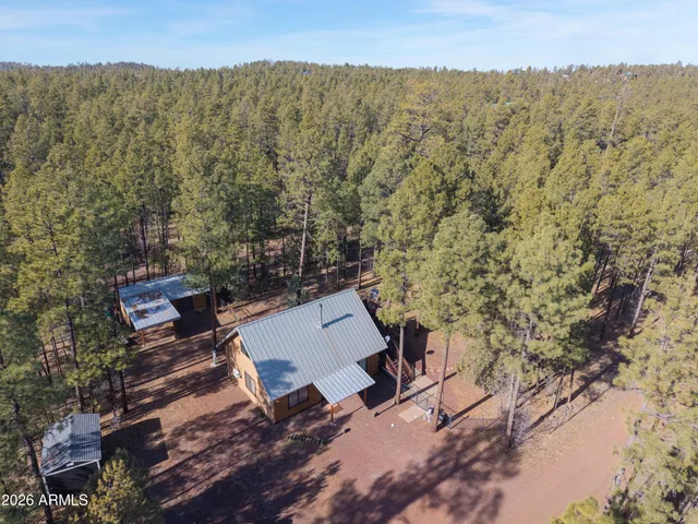 an aerial view of a house with a yard