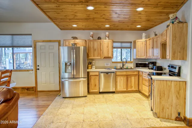 a kitchen with a refrigerator and a stove