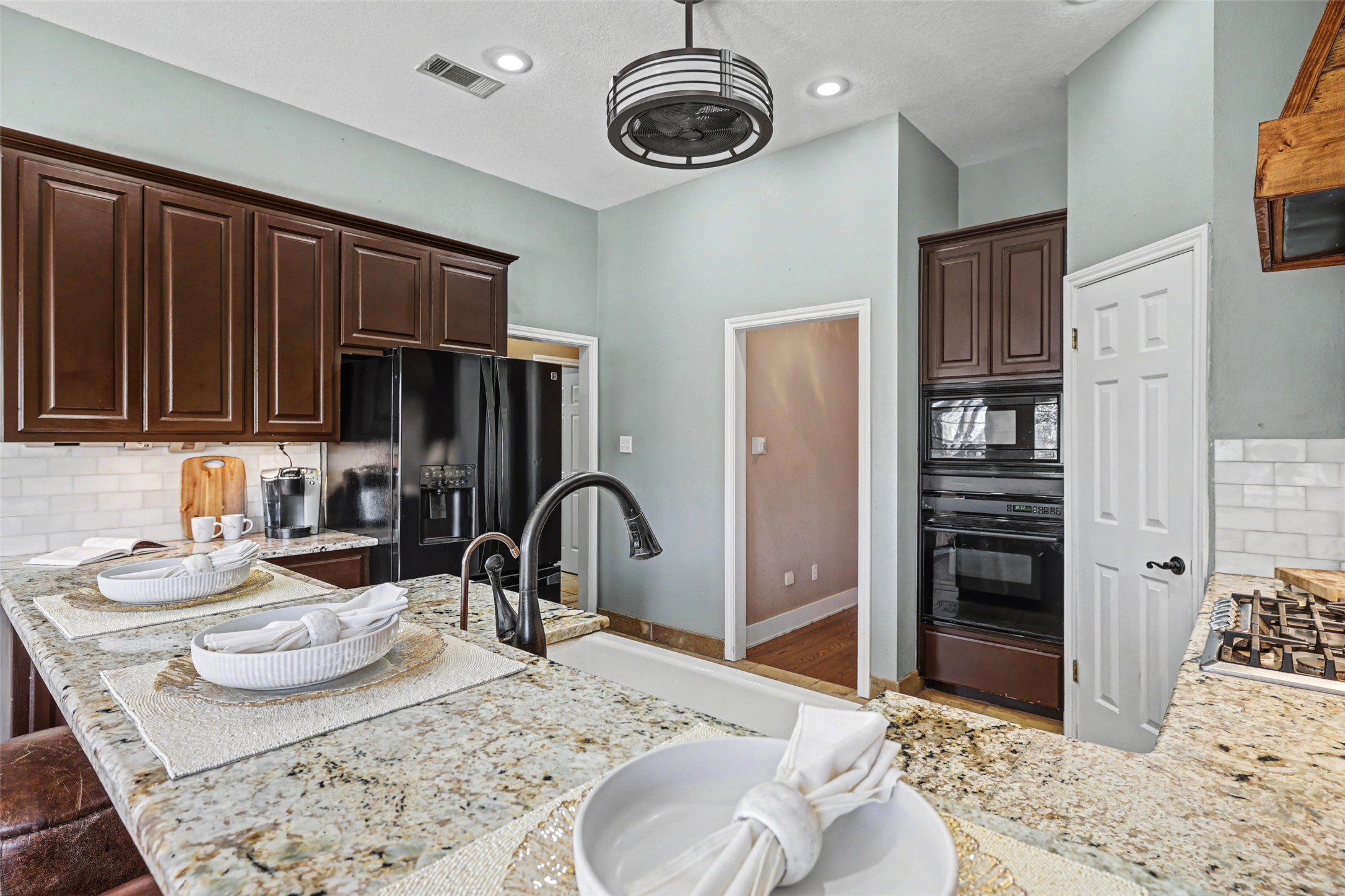 3022 Addie Lane Georgetown, TX 78628 - Photo 18 of 40 a kitchen with stainless steel appliances granite countertop a stove refrigerator and cabinets