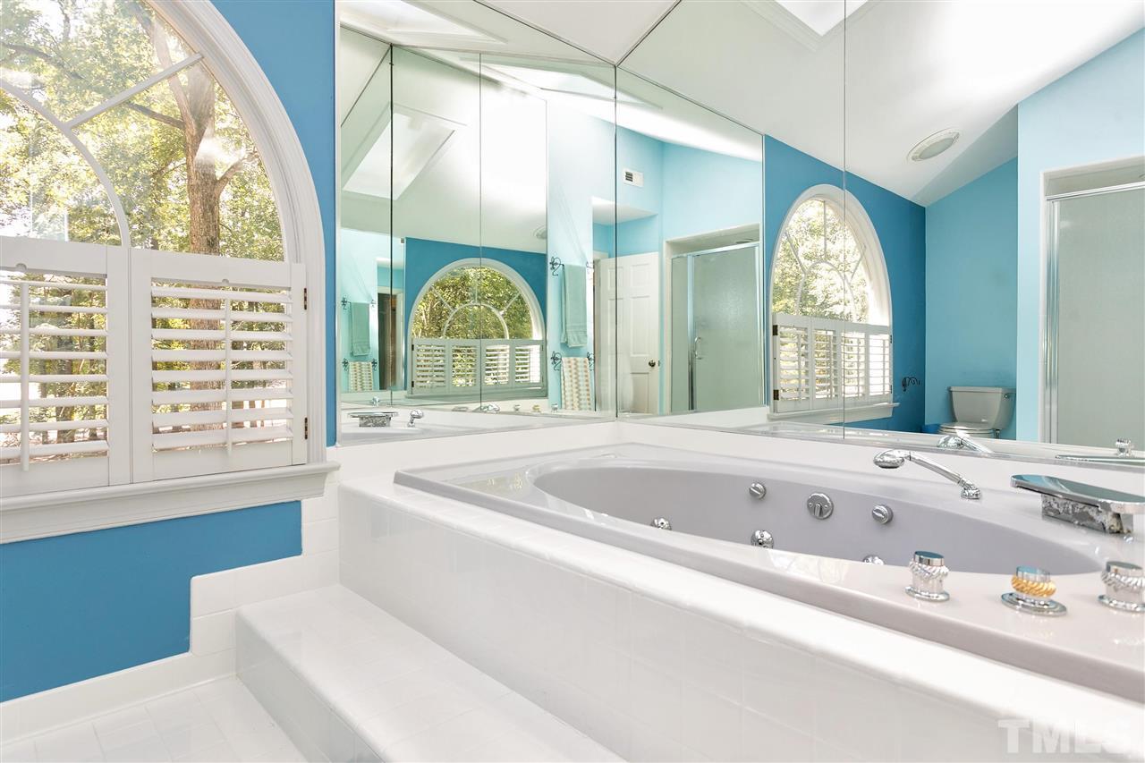 305 Queensferry Road Cary, NC 27511 - Photo 15 of 28 a bath tub sitting in a bathroom next to a window