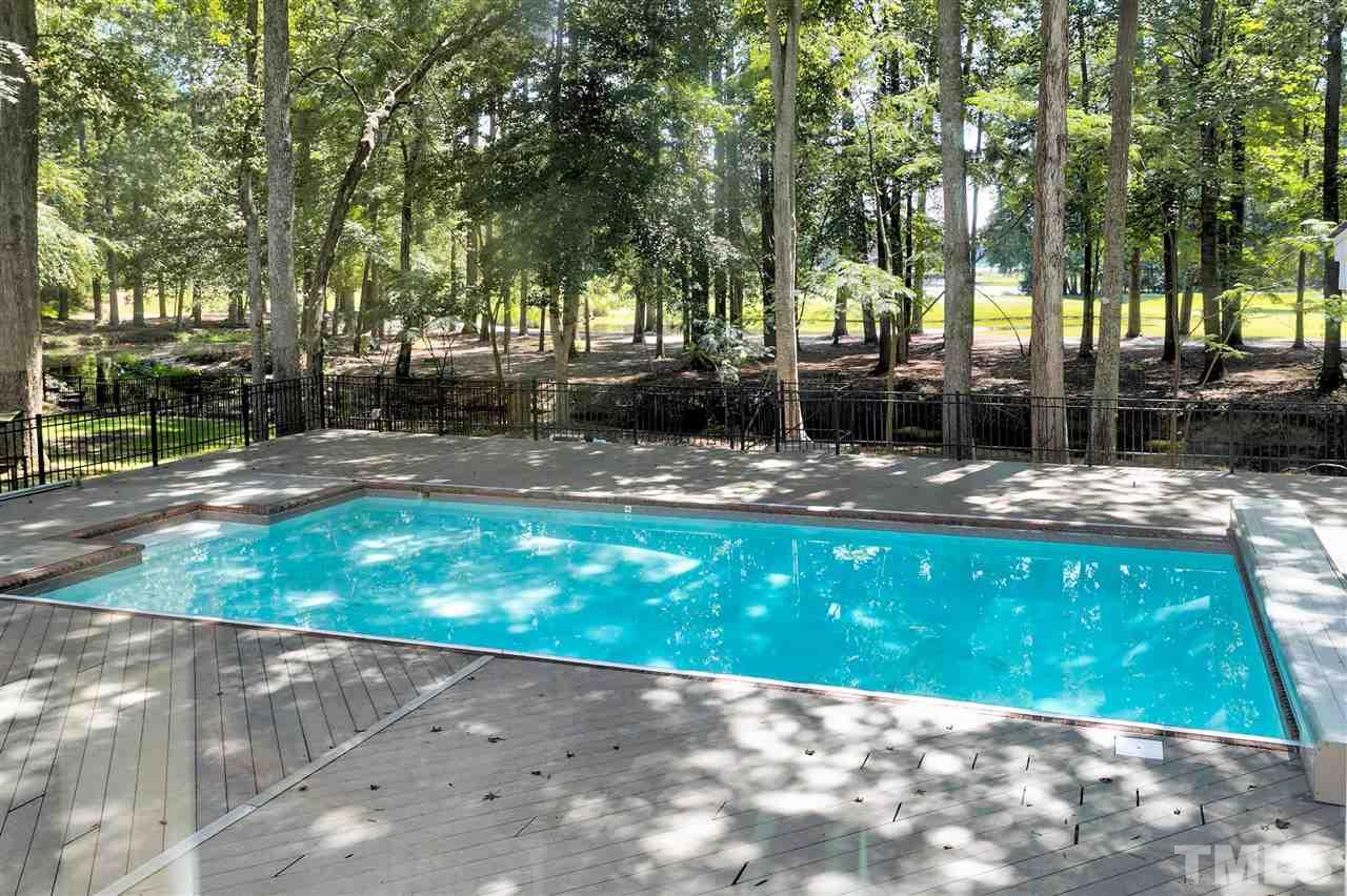 305 Queensferry Road Cary, NC 27511 - Photo 23 of 28 a view of a patio with a table and chairs under a large tree