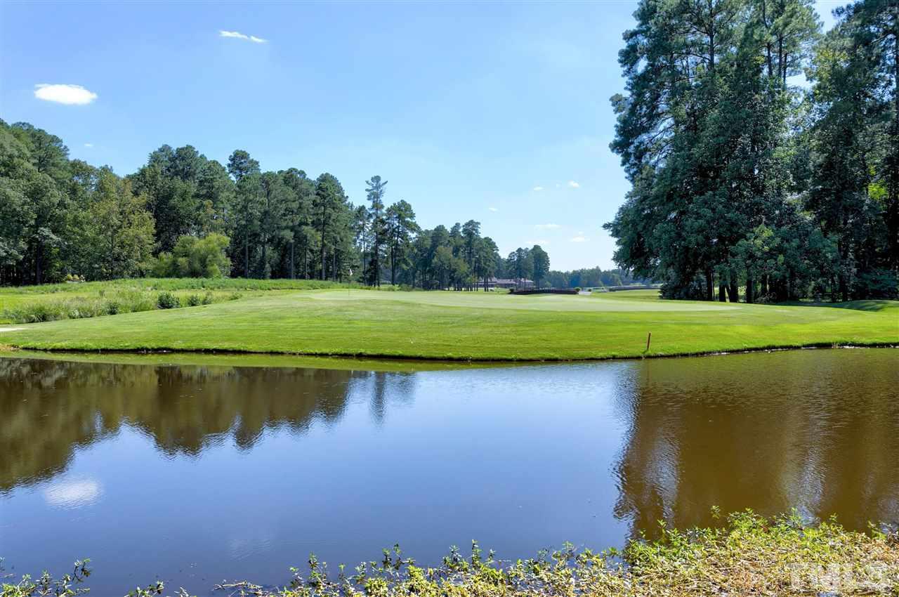 305 Queensferry Road Cary, NC 27511 - Photo 26 of 28 a view of a lake with a house in the background