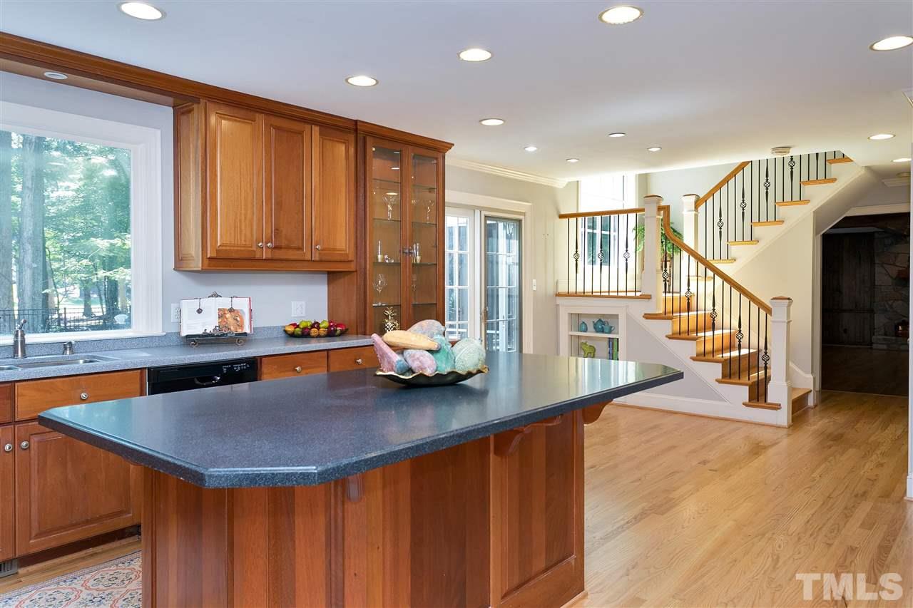305 Queensferry Road Cary, NC 27511 - Photo 6 of 28 a kitchen with a sink a counter top space and living room view
