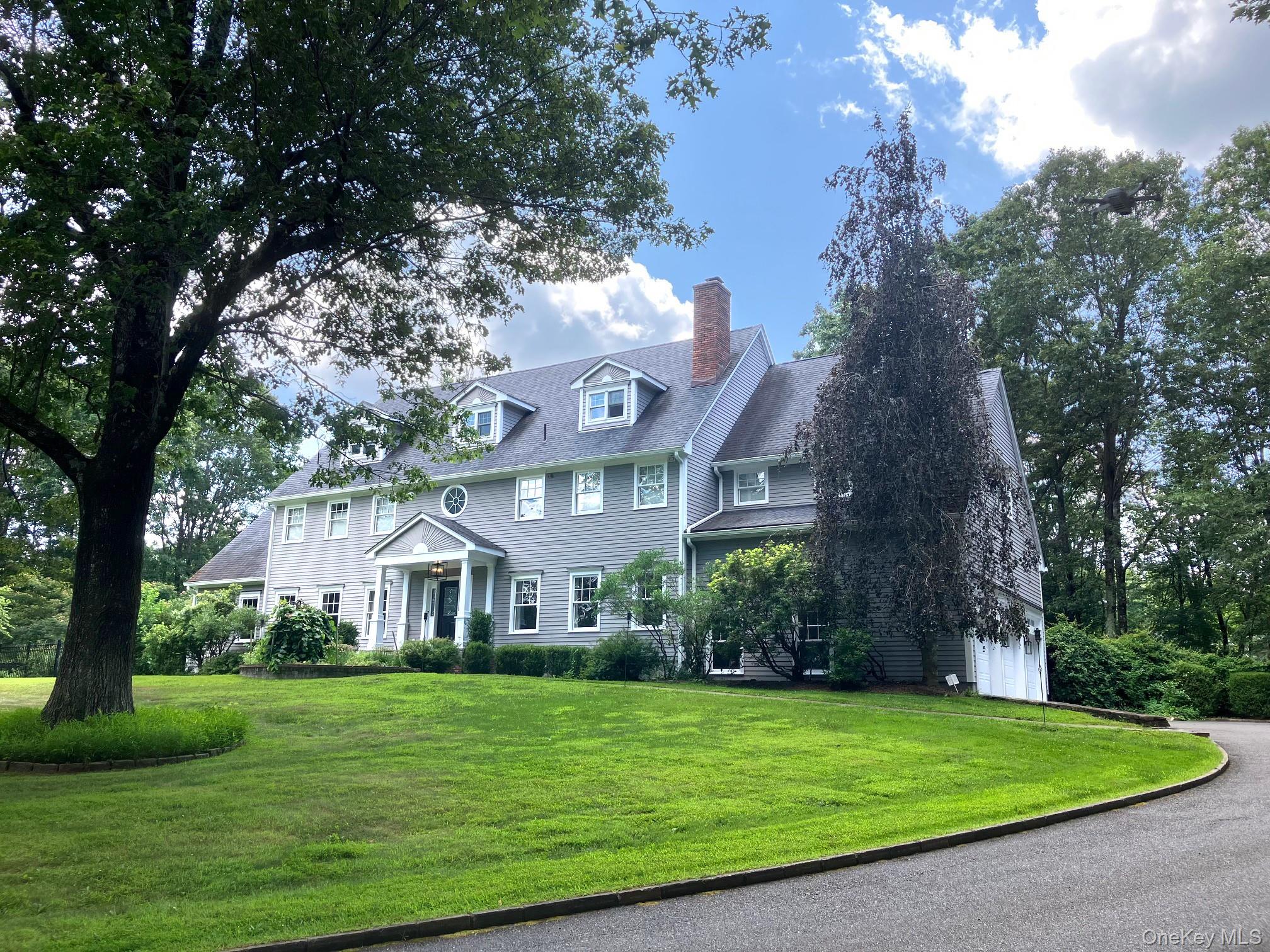 36 Scofield Road Pound Ridge, NY 10576 - Photo 1 of 1 a front view of a house with a garden