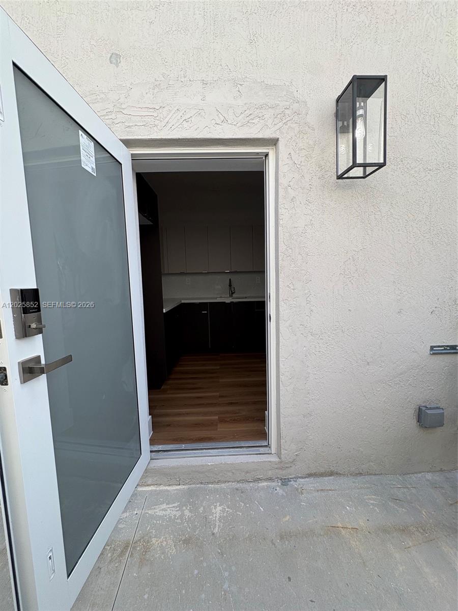 12948 Southwest 265th Terrace, Unit STUDIO Homestead, FL 33032 - Photo 6 of 16 a room that has a door and a window