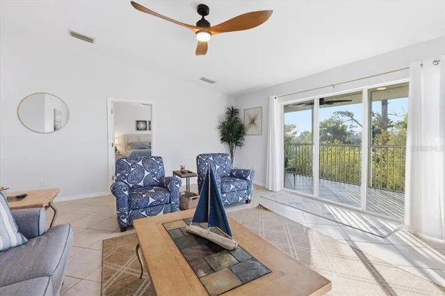 a spacious bedroom with a large bed and a chandelier