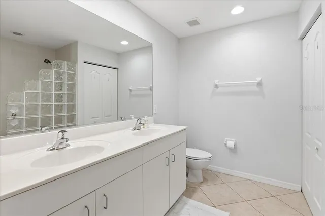 a bathroom with a toilet a sink and shower