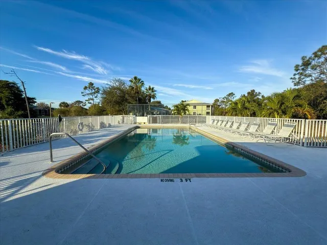 an aerial view of house with yard swimming pool and outdoor seating