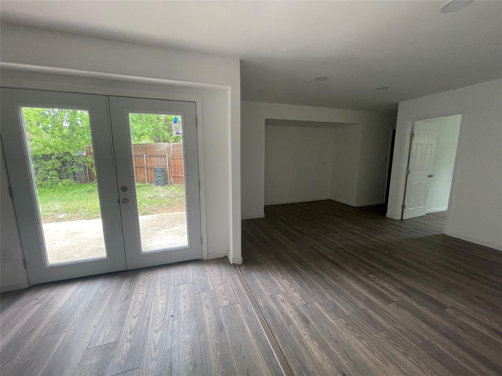 3 Ridge Drive Hickory Creek, TX 75065 - Photo 9 of 20 a view of an empty room with wooden floor and a window