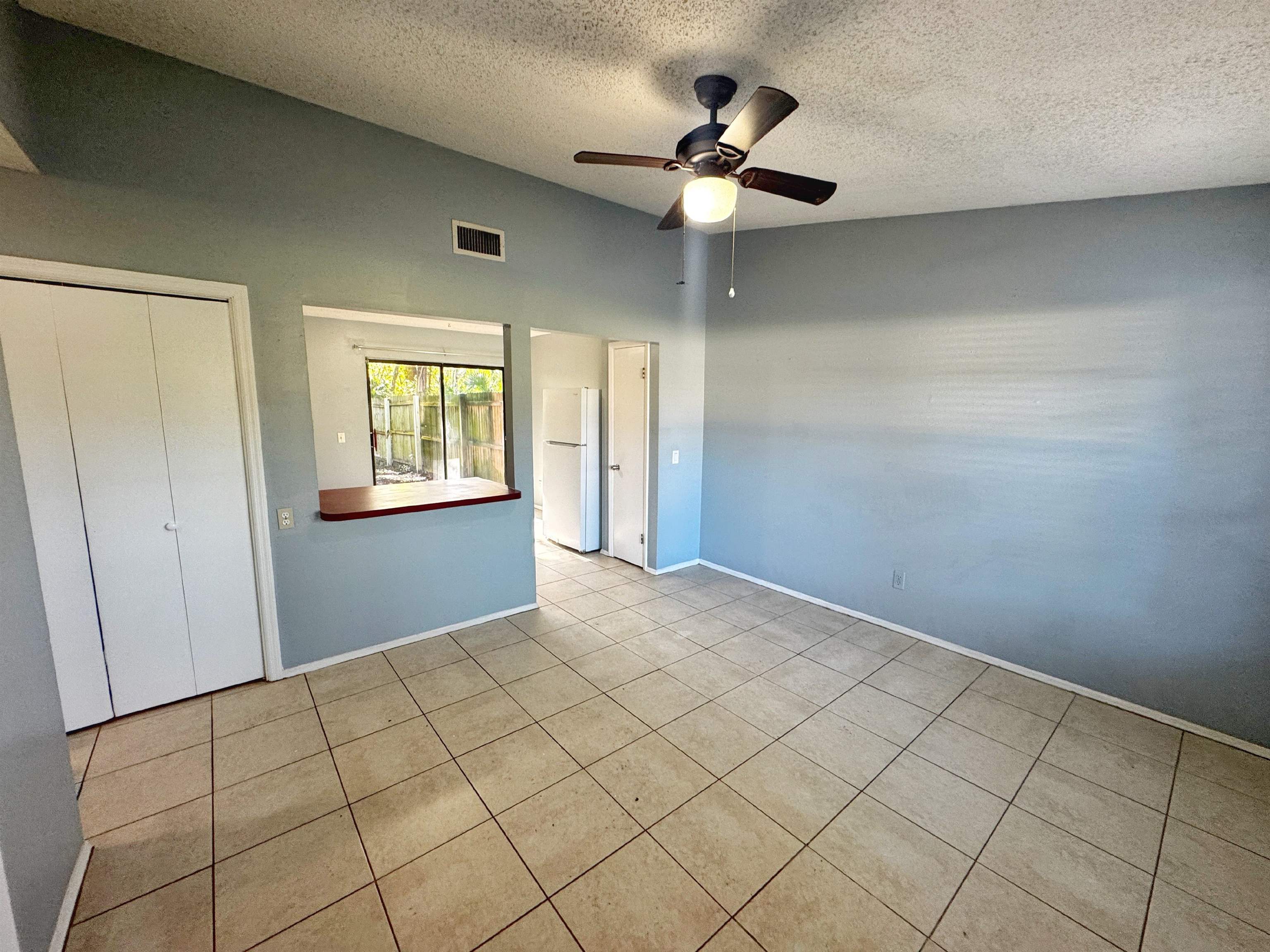 5950 Highway 1, Unit A St. Augustine, FL 32086 - Photo 2 of 13 an empty room with windows and fan