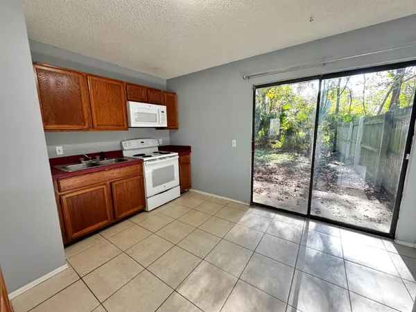 a kitchen with a stove a sink and a refrigerator