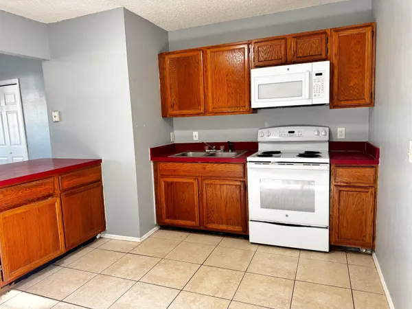 a kitchen with stainless steel appliances granite countertop a stove and a microwave