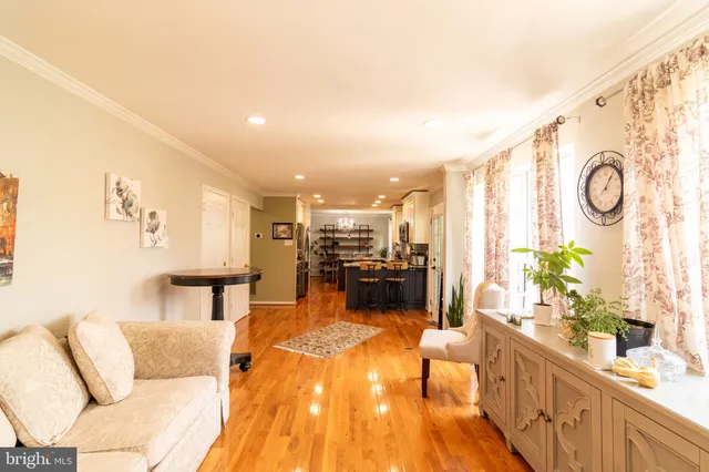 a living room with furniture and kitchen view
