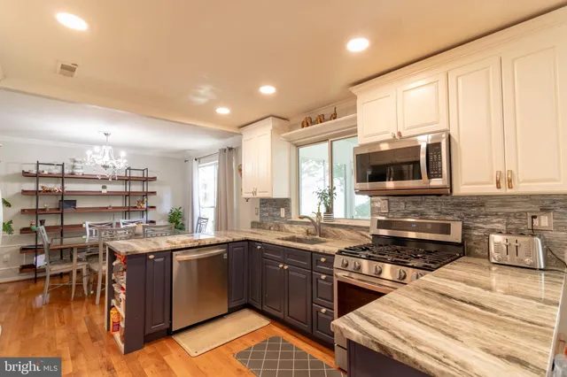 a kitchen with a stove a sink and a microwave