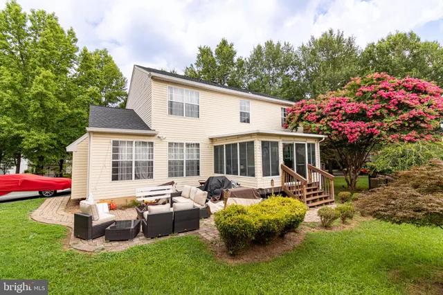 a front view of house with yard outdoor seating and green space