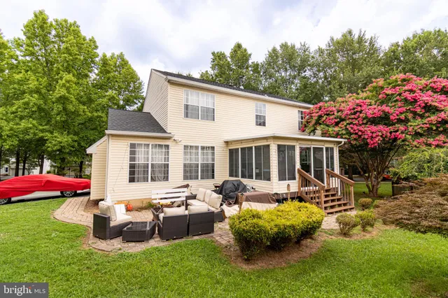 a front view of house with yard and outdoor seating