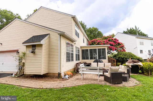 a view of a house with backyard sitting area and garden