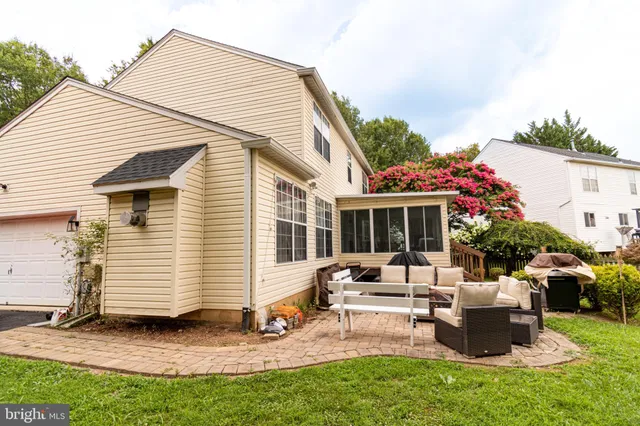 a view of a house with backyard porch and sitting area