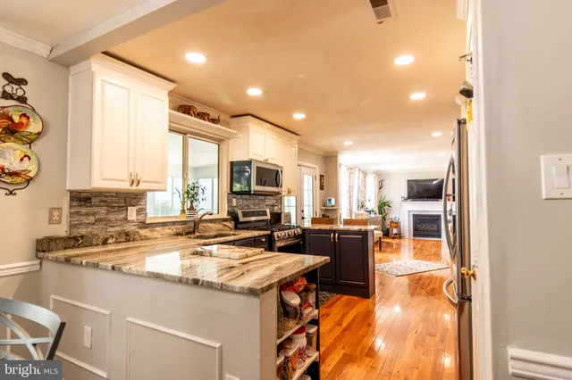 a kitchen with a stove a sink and a refrigerator