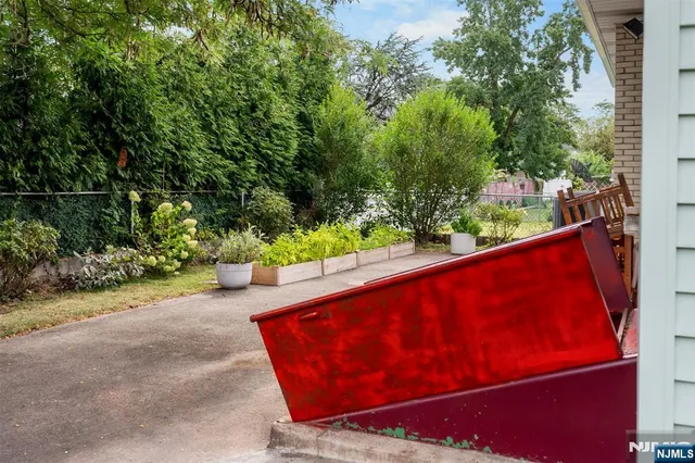 a view of backyard of house with wooden stairs