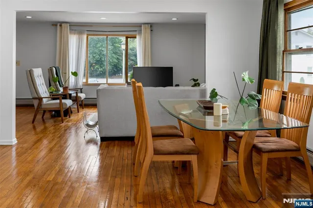 a view of a dining room with furniture and wooden floor
