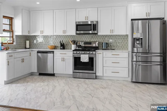 a kitchen with granite countertop a stainless steel appliances and cabinets