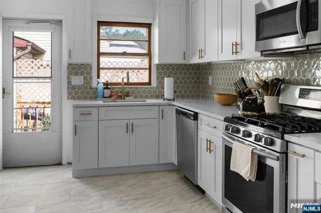 a kitchen with cabinets appliances and a window