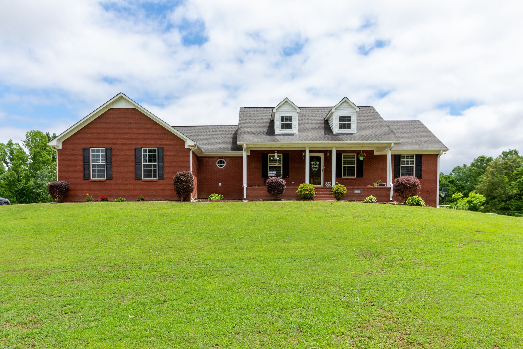 1155 Johnson Branch Road Pulaski, TN 38478 - Photo 1 of 45 a view of a big house with a big yard and large trees