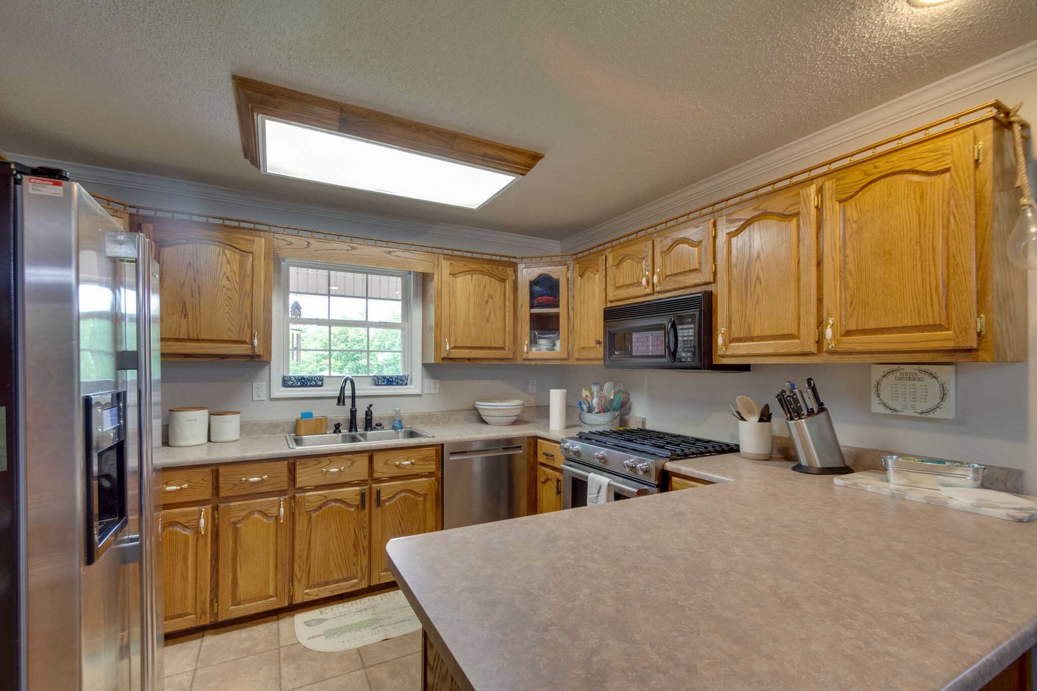 1155 Johnson Branch Road Pulaski, TN 38478 - Photo 11 of 45 a kitchen with a sink a stove cabinets and a dining table