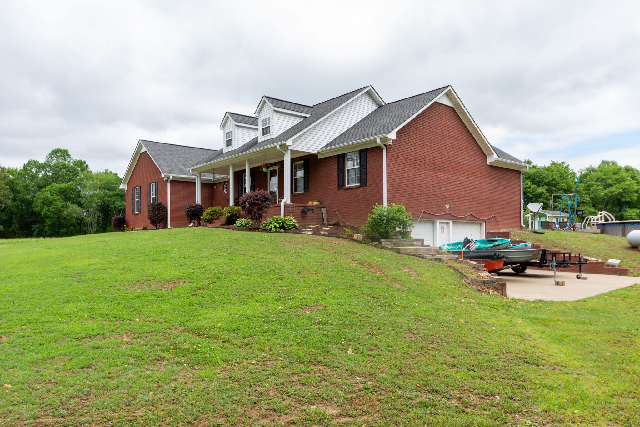 1155 Johnson Branch Road Pulaski, TN 38478 - Photo 2 of 45 a front view of a house with garden and trees