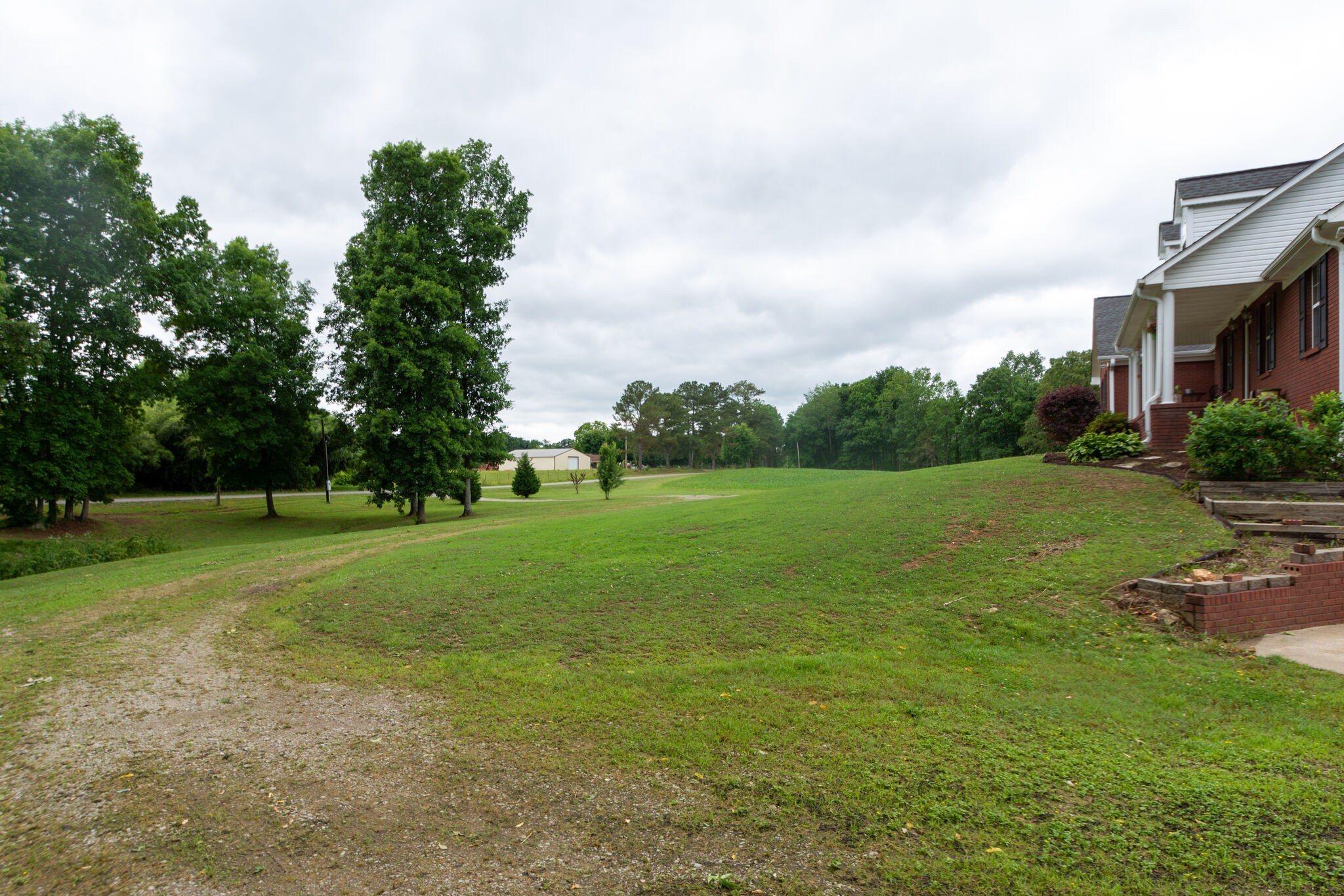 1155 Johnson Branch Road Pulaski, TN 38478 - Photo 43 of 45 a view of a grassy field with trees in the background