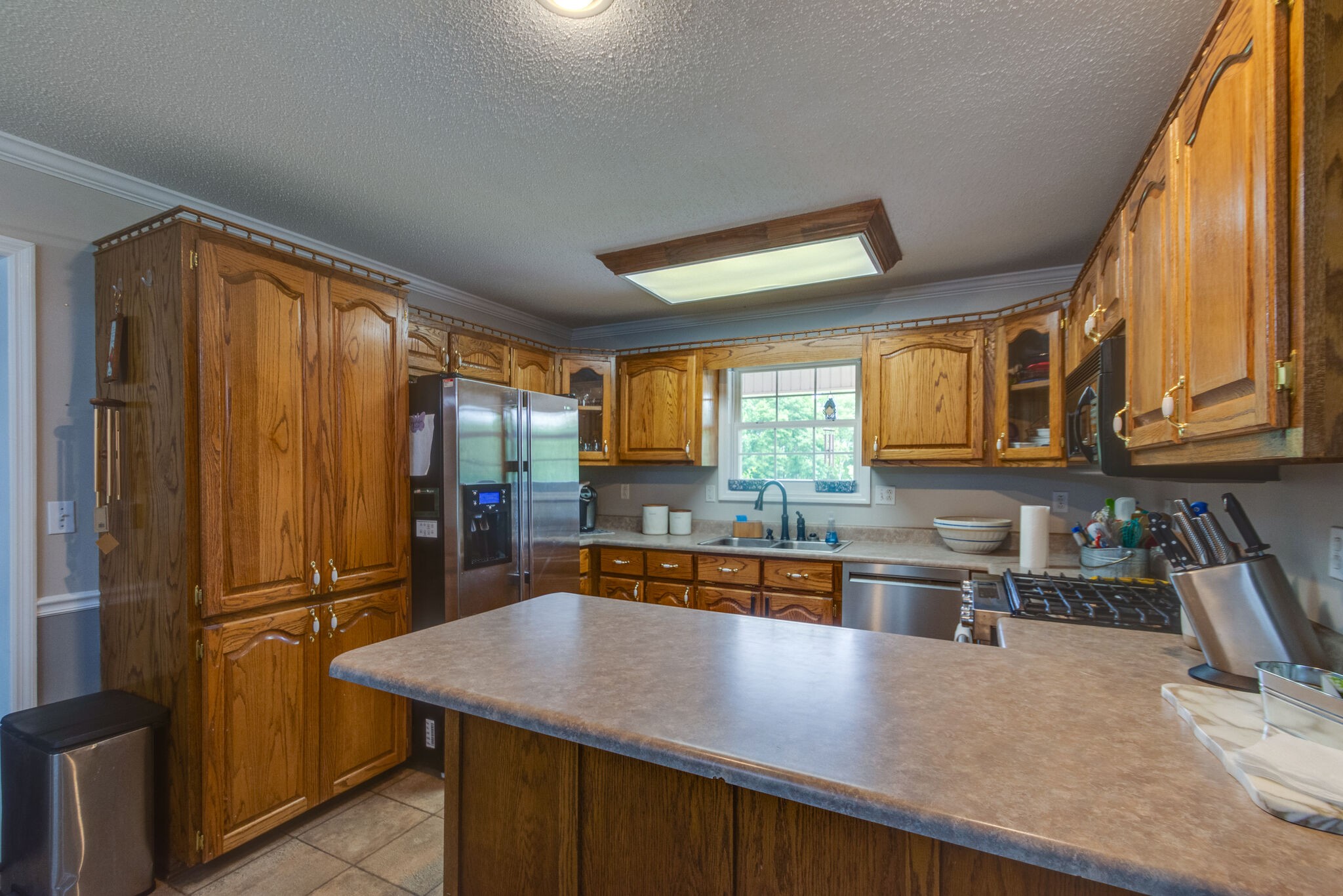 1155 Johnson Branch Road Pulaski, TN 38478 - Photo 10 of 45 a kitchen with stainless steel appliances granite countertop a sink refrigerator and cabinets