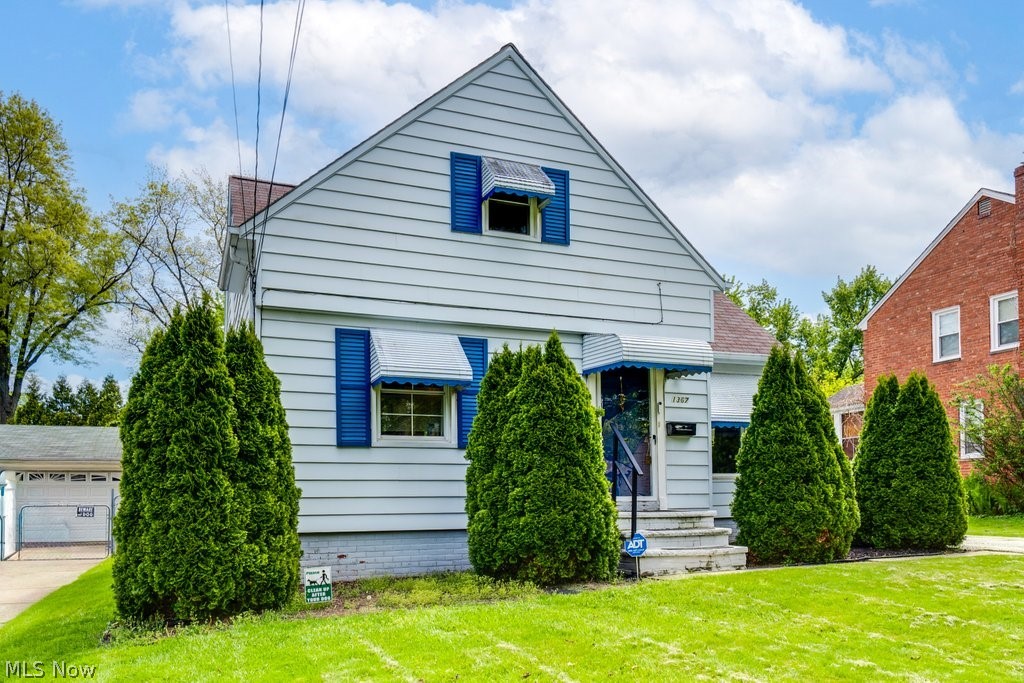 1367 Churchill Road Lyndhurst, OH 44124 - Photo 2 of 30 Light-colored siding exterior with blue shutters and awnings